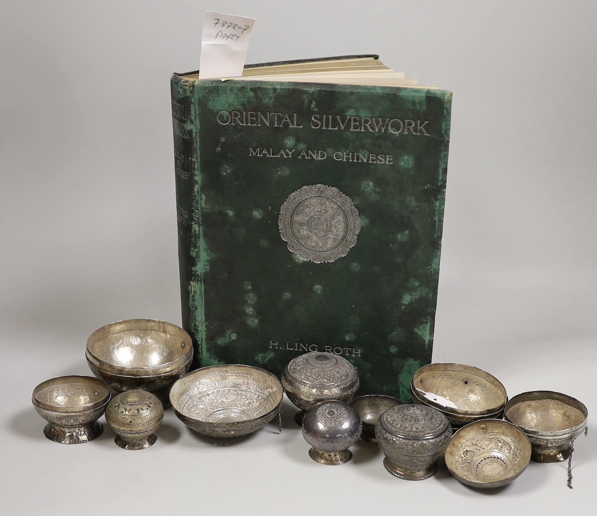 A collection of Malay Straits white metal circular betel nut boxes ('Chimbul'), comprising seven boxes and covers of various sizes (some damaged or missing chain fastenings) and two boxes lacking covers, gross weight 881